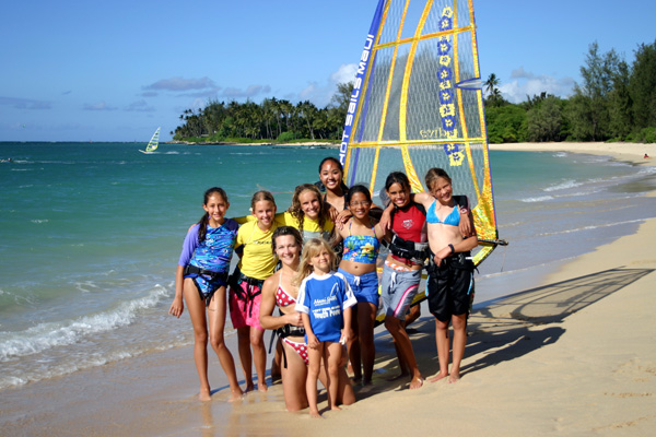 a group of people on a beach near a body of water