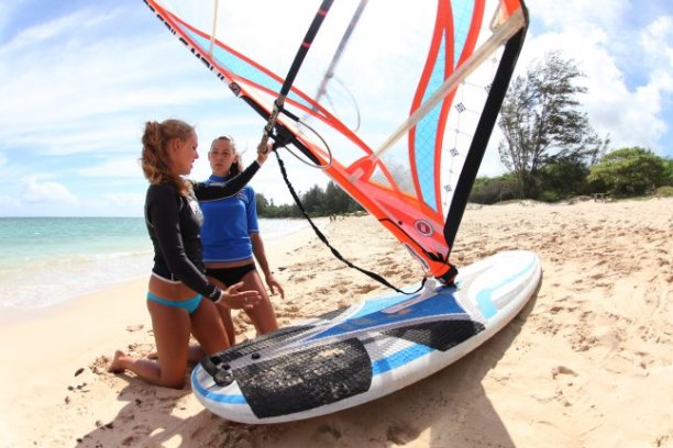 a person flying a kite on the beach