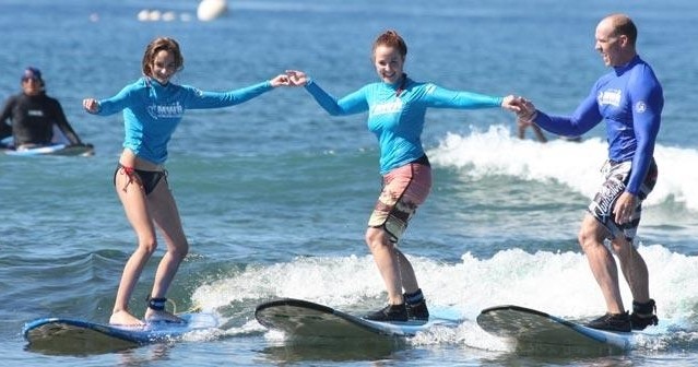 “Beginner surfers catching their first waves in Maui — the ultimate bucket list adventure.”