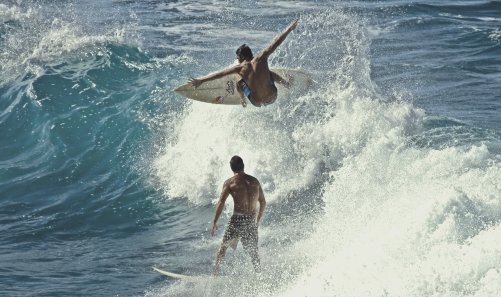 a man riding a wave on a surfboard in the ocean